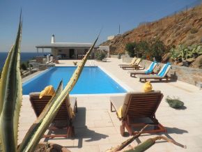 The big veranda with swimming pool, sunbeds, and tables