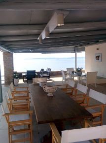 Three tables on the veranda with comfortable chairs